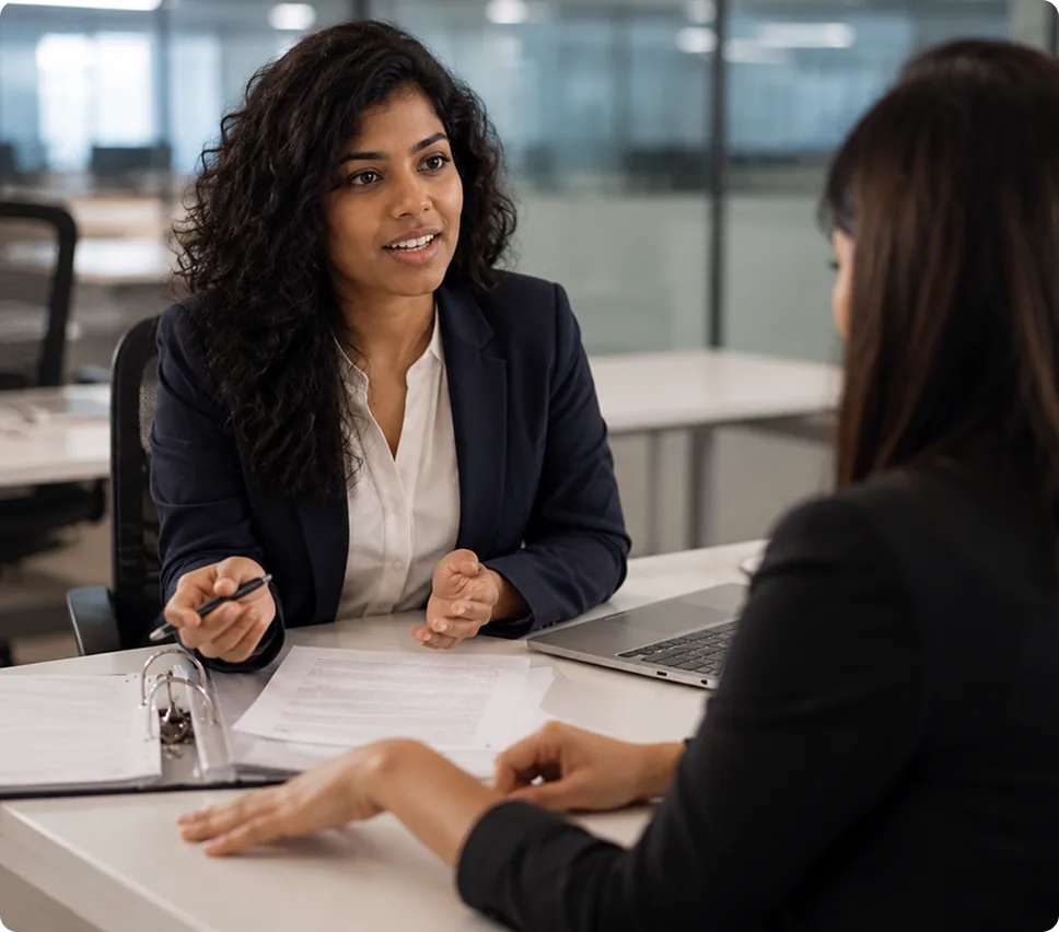 Banking professionals discussing workforce policies and documents at a branch office desk