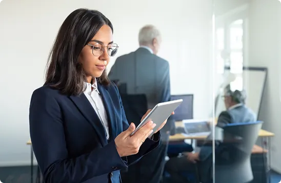Compliance professional working at a desktop computer