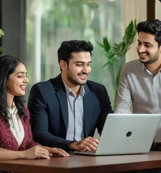 Three colleagues collaborating around a laptop in a bright office environment