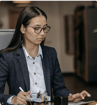 HR operations professional working at a laptop