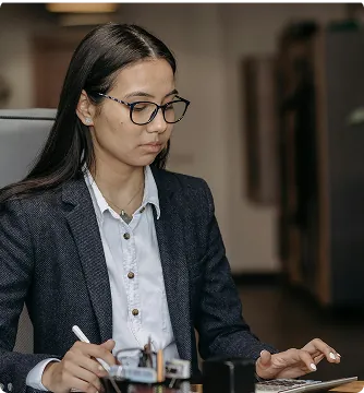 HR operations professional working at a laptop