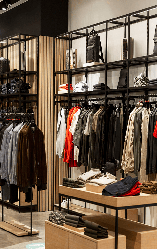 Organized retail store interior with apparel displays and shelving