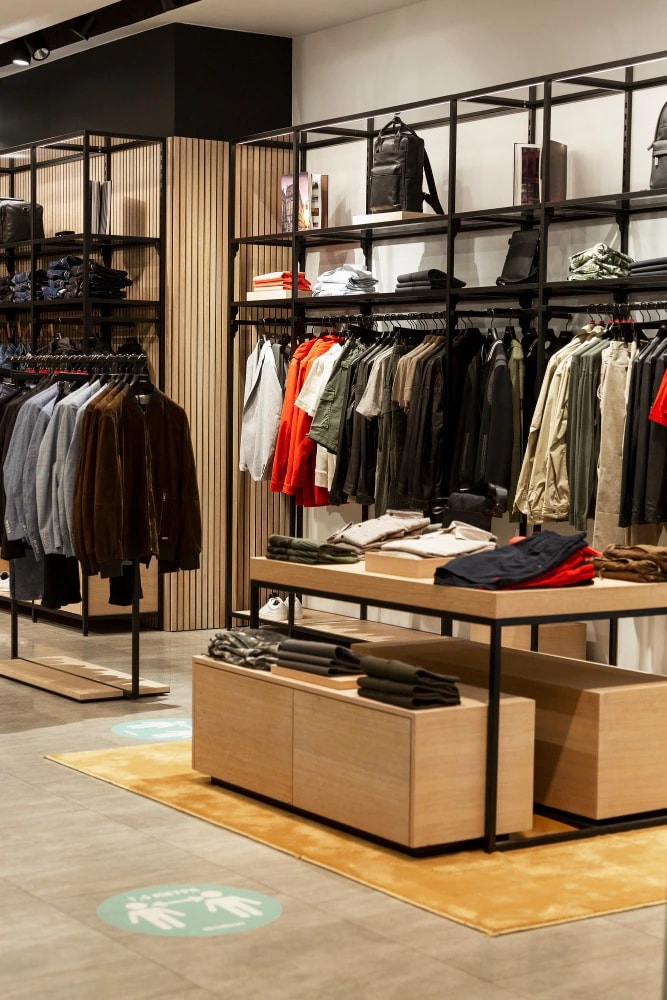 Organized retail store interior with apparel displays and shelving