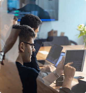 IT professional using a tablet in a meeting room