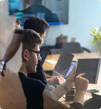 IT professional using a tablet in a meeting room