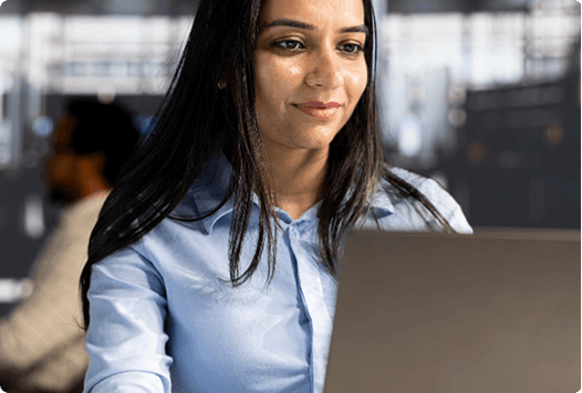 IT professional working on a laptop in an office