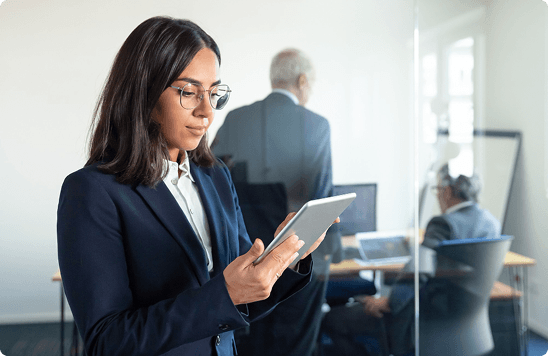 Compliance consultant reviewing workforce records on a tablet