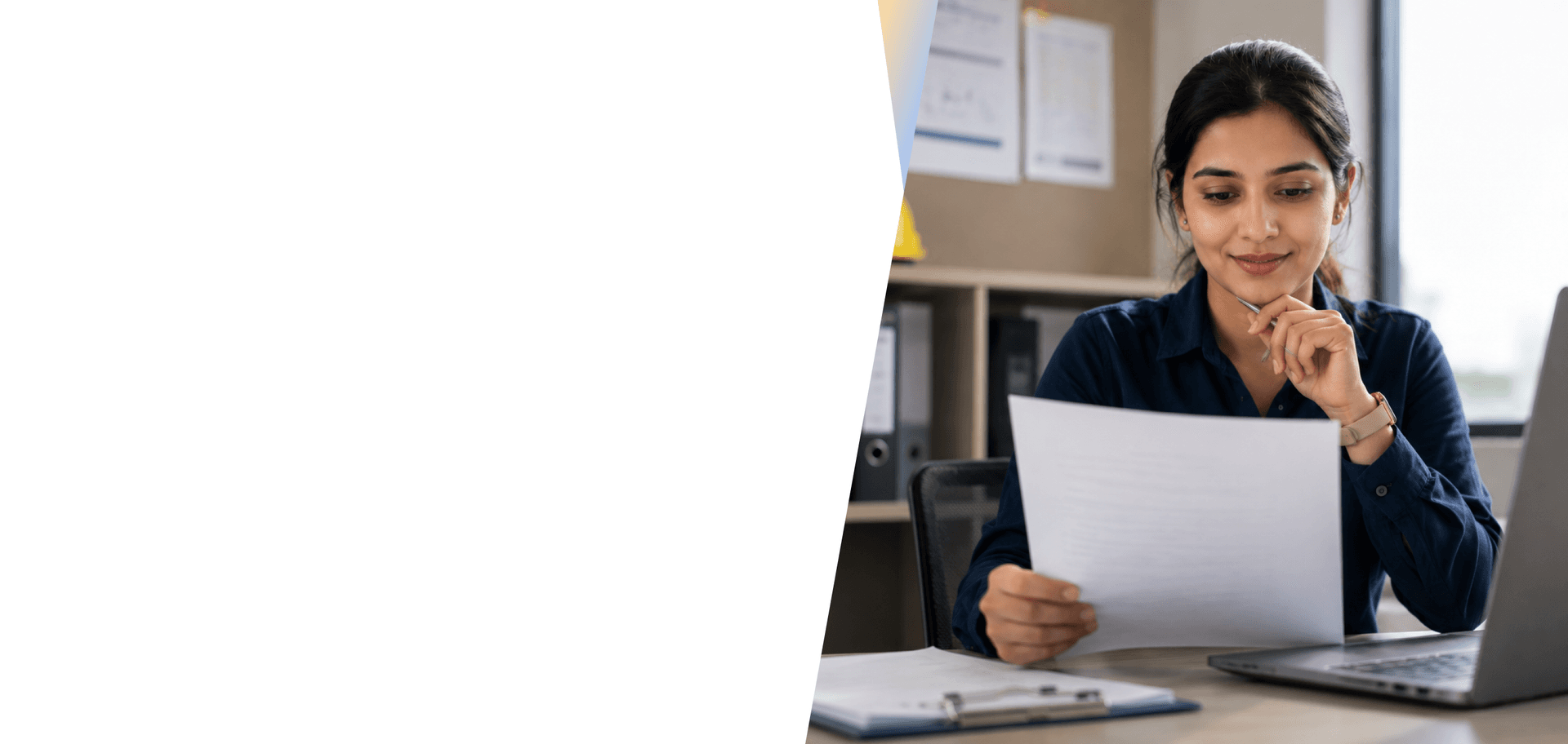 Payroll professional reviewing salary documents at a desk in an office