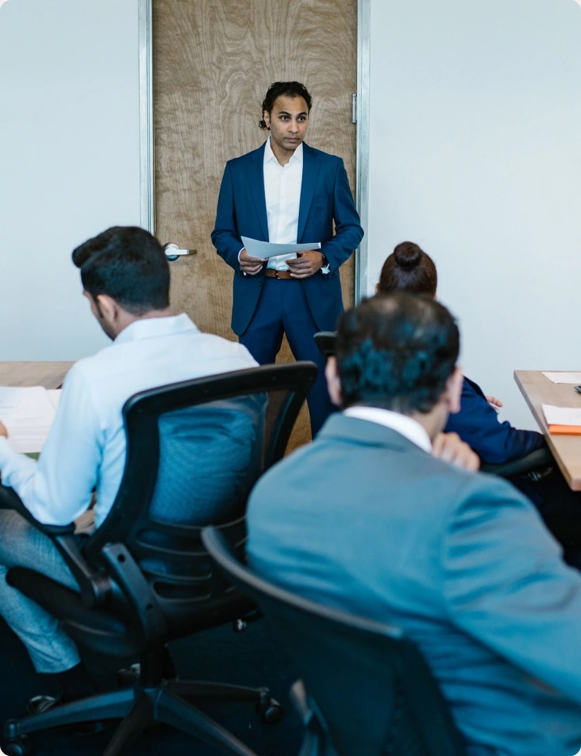 Business leader presenting to a team in a conference room