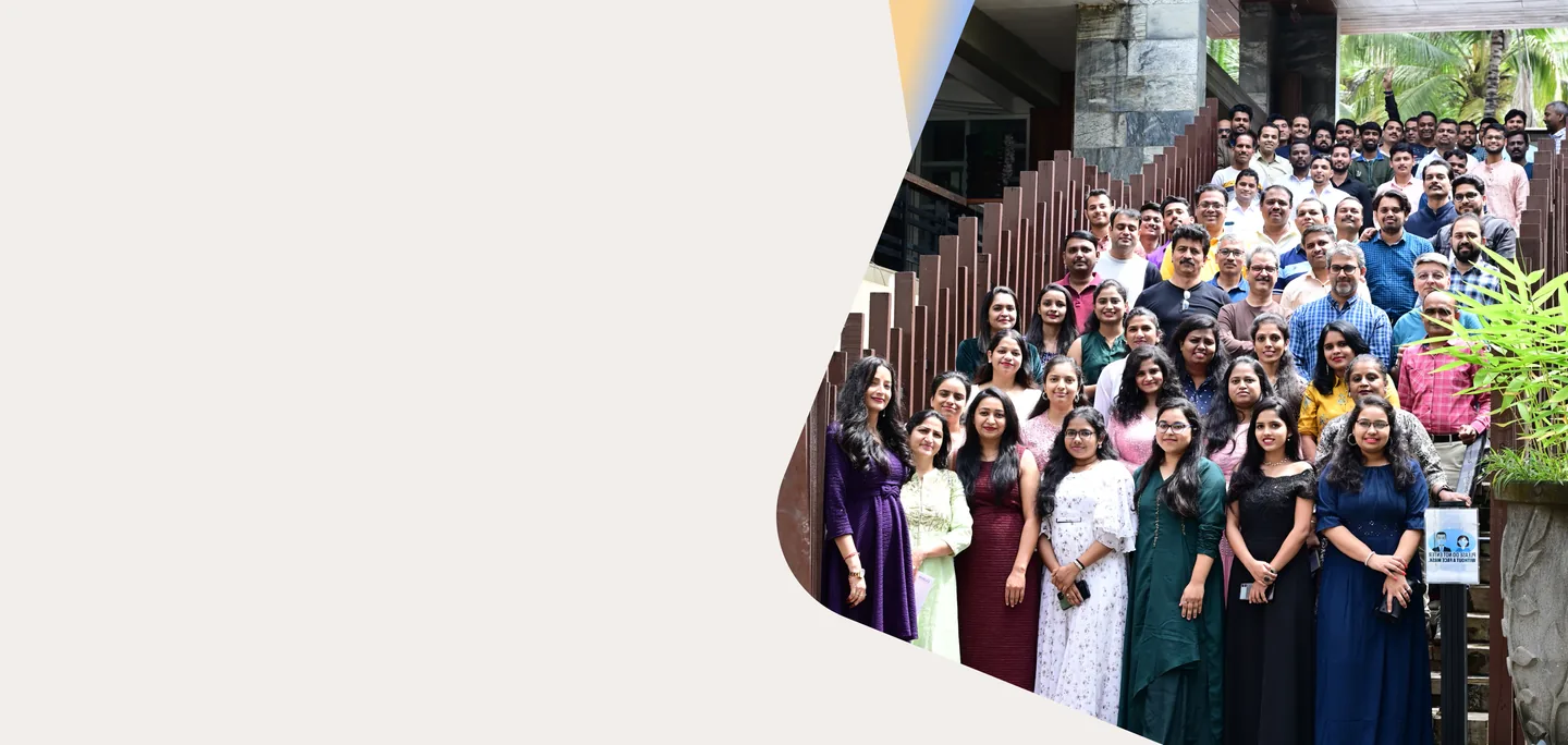 Large group of Eilisys team members standing together on outdoor steps at the company campus