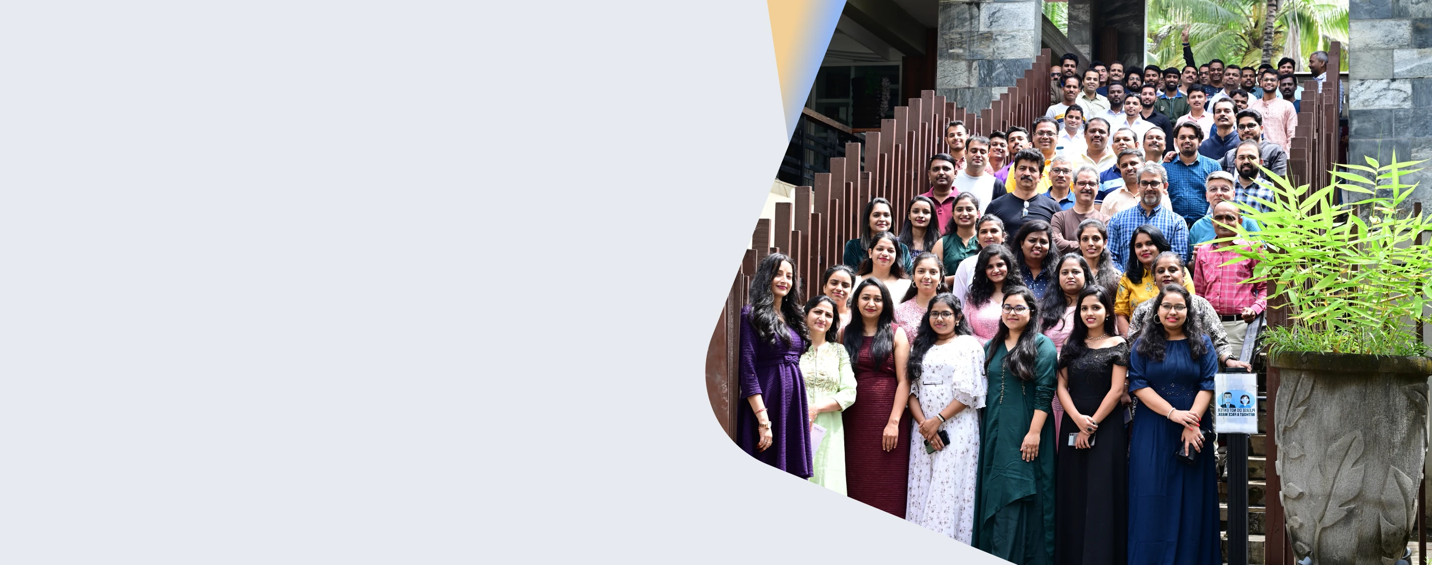 Large group of Eilisys team members standing together on outdoor steps at the company campus