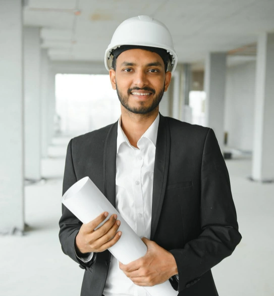 Plant HR leader in a hard hat holding project plans on a construction site