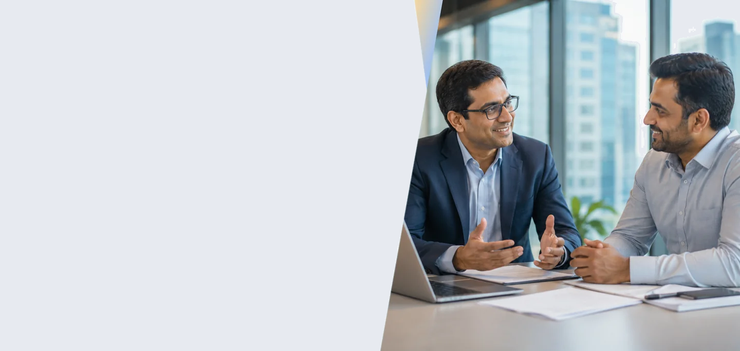 Two business professionals discussing workforce management in a modern office with city views